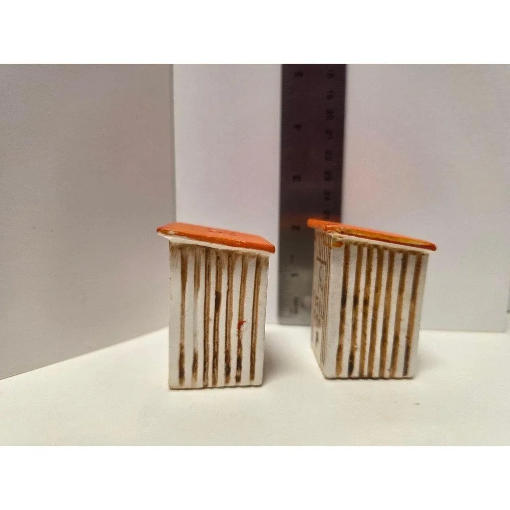 vintage, comical salt and pepper shakers feature an outhouse design with humorou